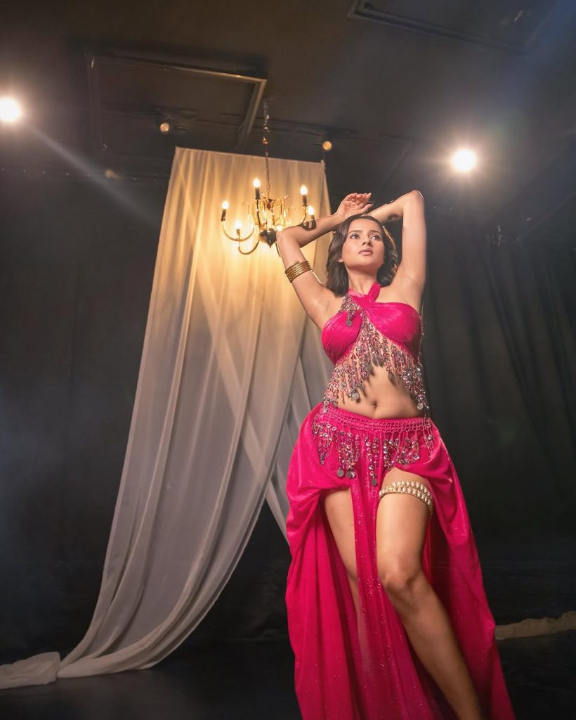 Aarushi Baruah posing confidently in fitted pink dress outfit