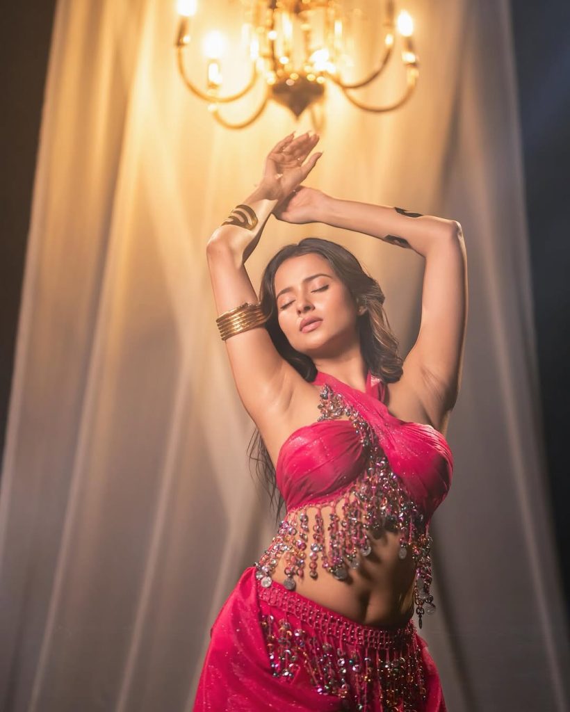 Aarushi Baruah posing confidently in fitted pink dress outfit