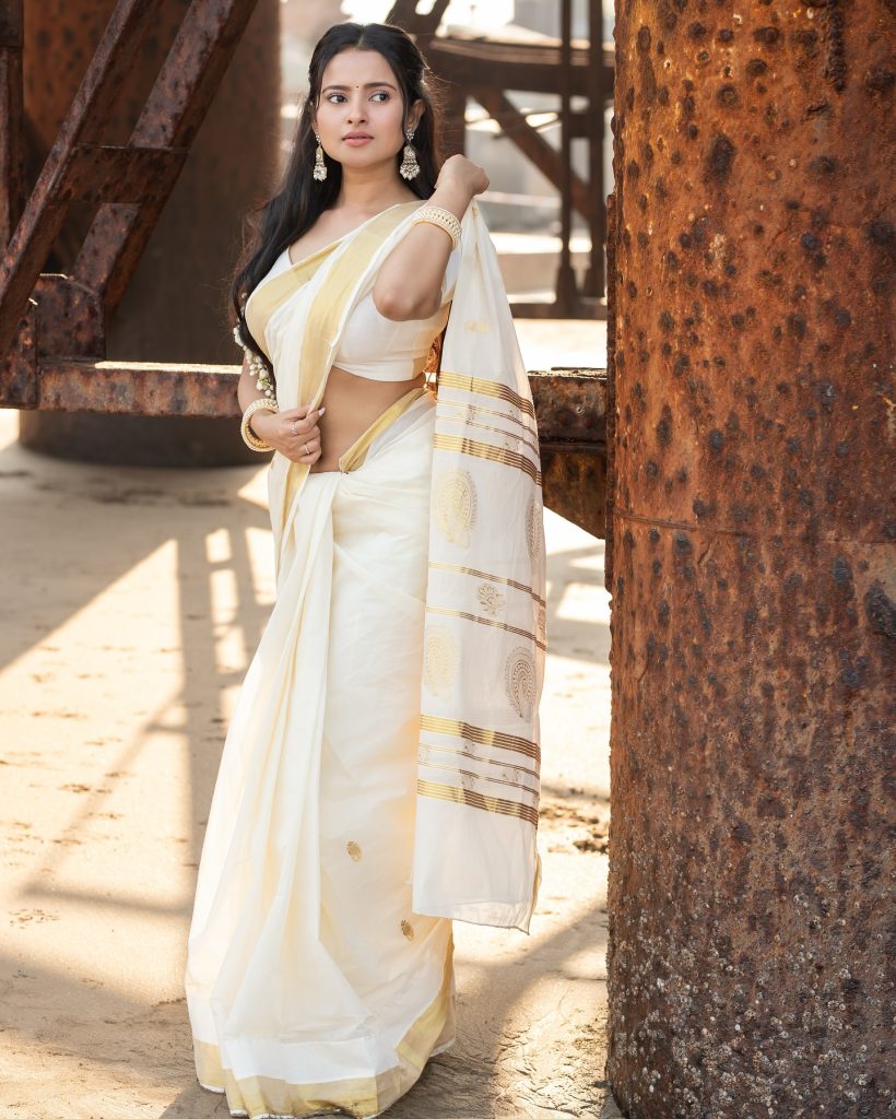 Close-up of Aarushi Baruah's makeup and styling with white saree