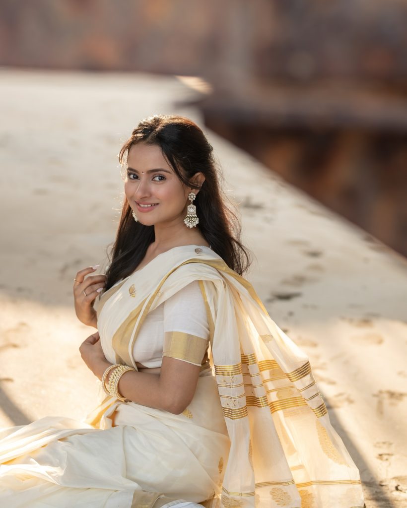Close-up of Aarushi Baruah's makeup and styling with white saree