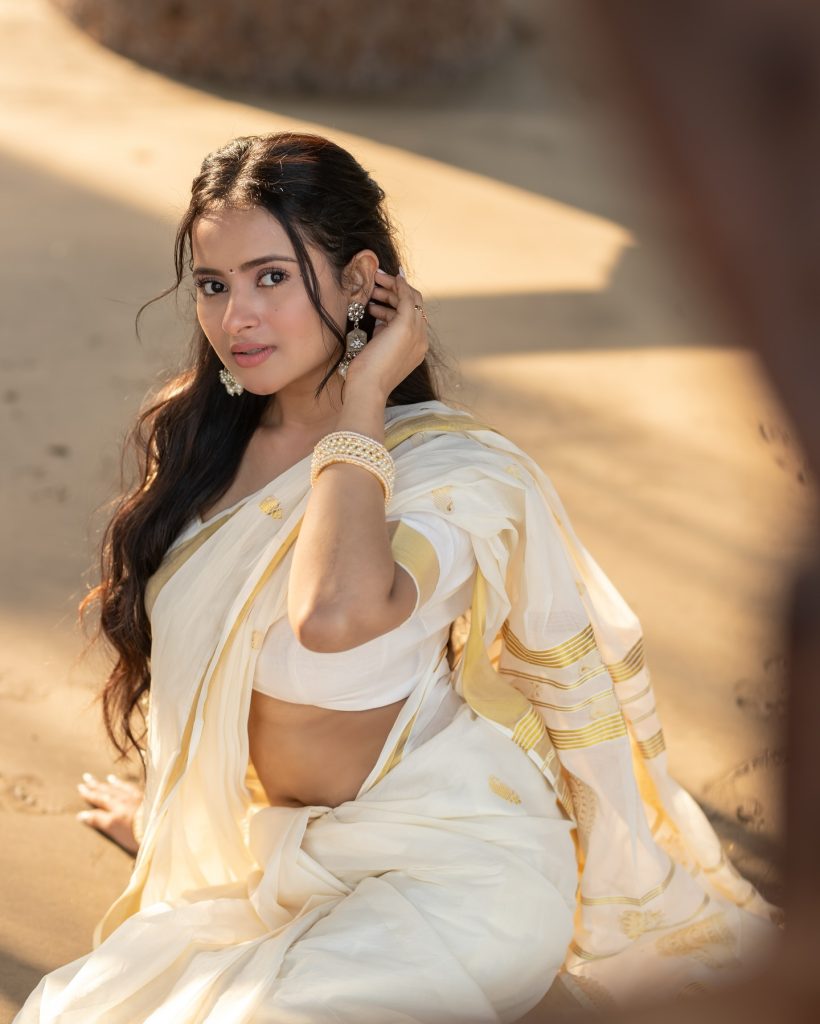 Close-up of Aarushi Baruah's makeup and styling with white saree