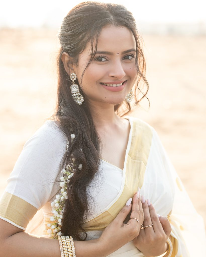 Close-up of Aarushi Baruah's makeup and styling with white saree