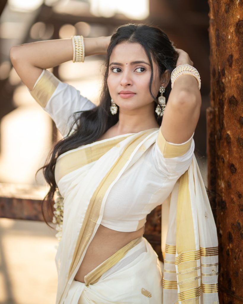 Close-up of Aarushi Baruah's makeup and styling with white saree