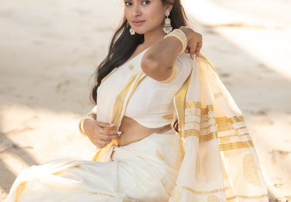 Aarushi Baruah posing gracefully in flowing white saree ensemble