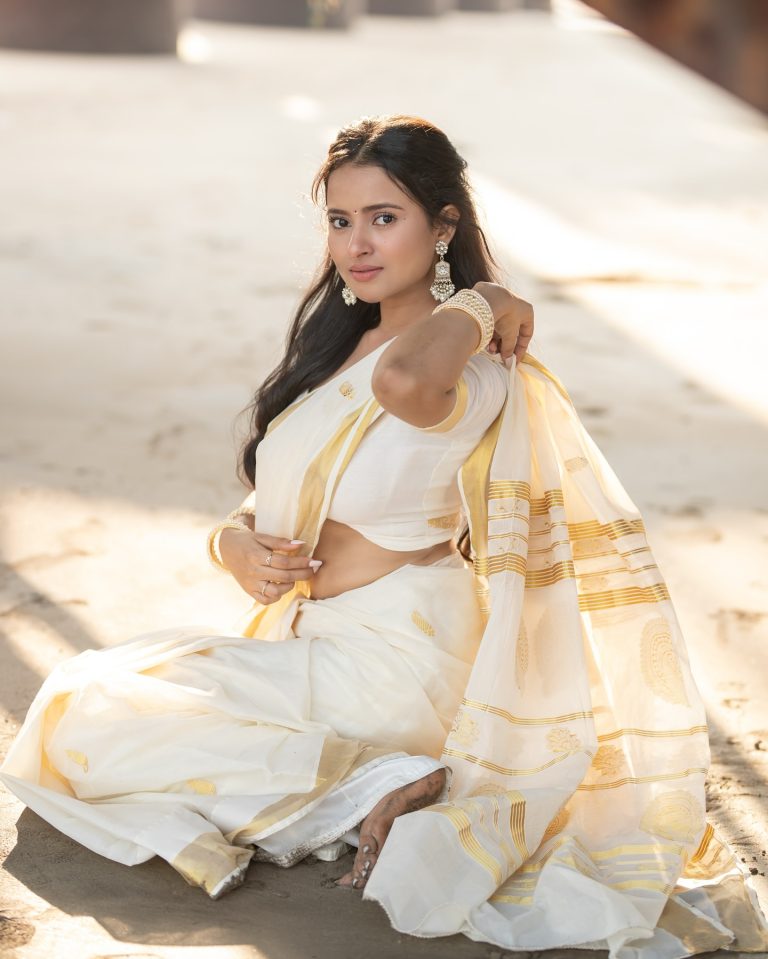 Aarushi Baruah posing gracefully in flowing white saree ensemble