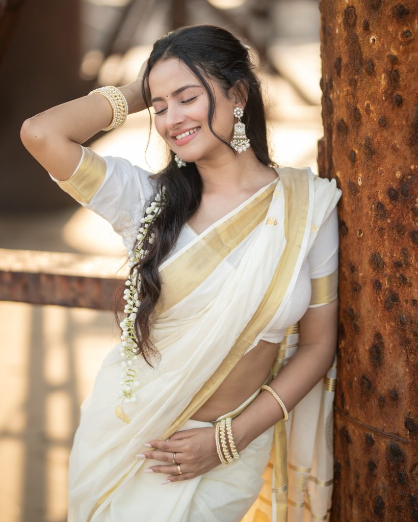 Aarushi Baruah posing gracefully in flowing white saree ensemble