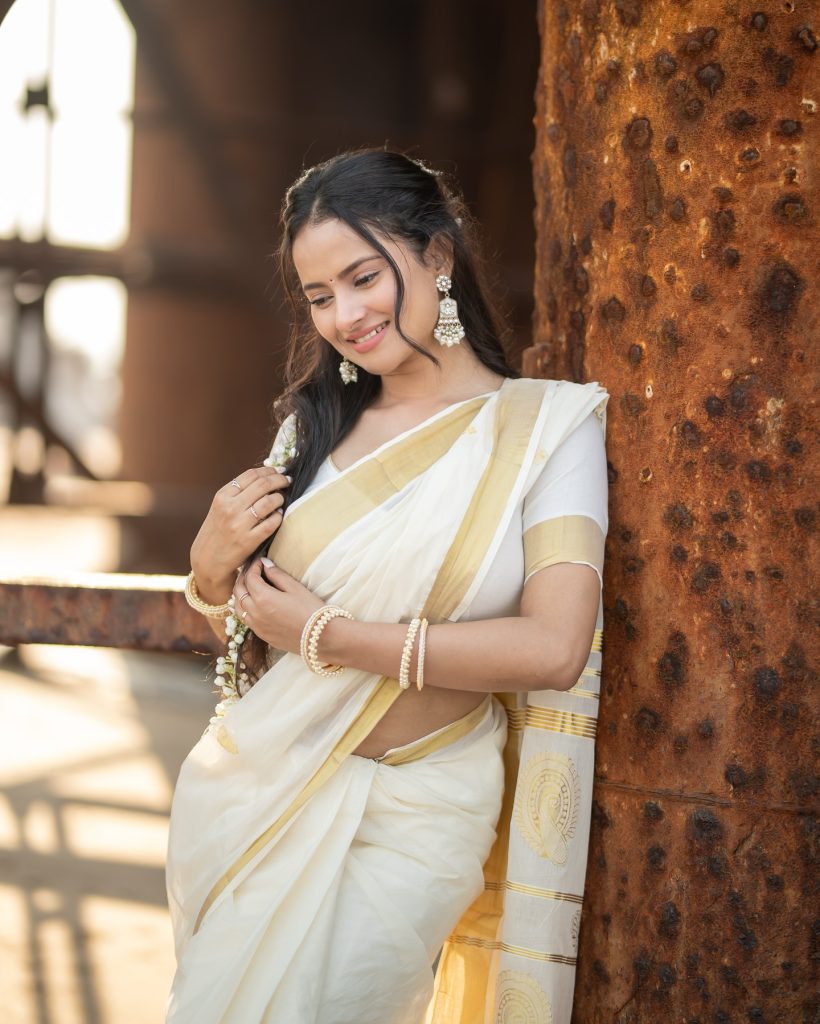 Aarushi Baruah posing gracefully in flowing white saree ensemble