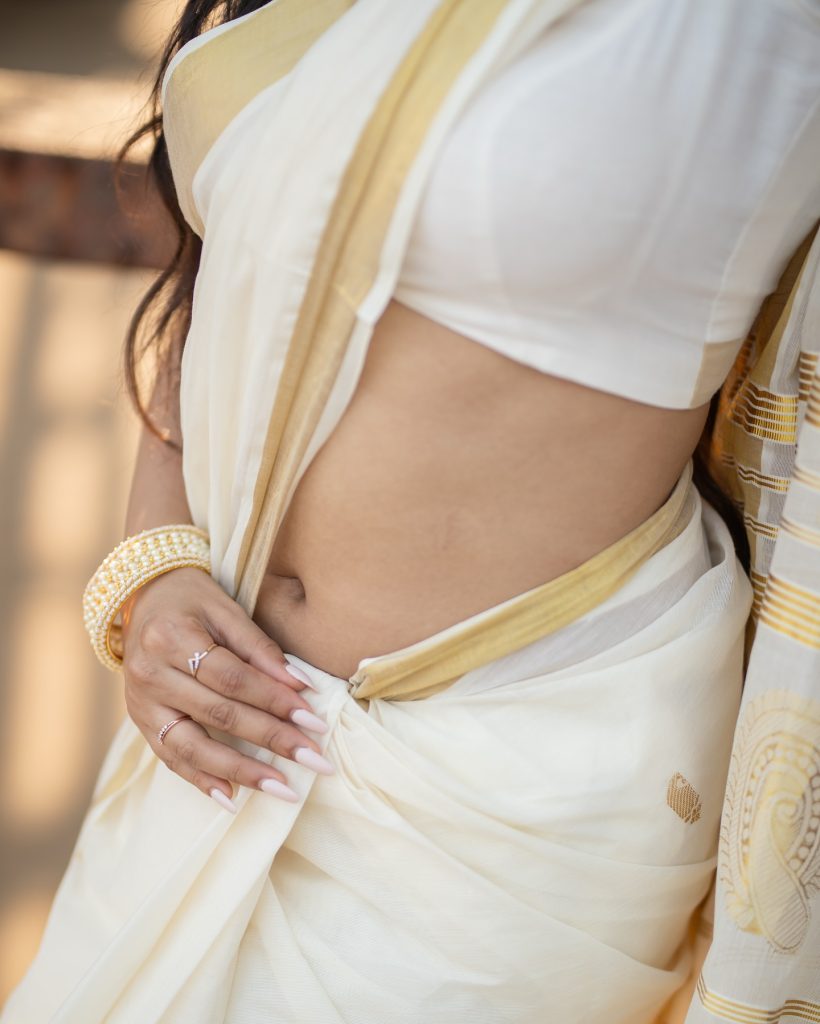 Aarushi Baruah posing gracefully in flowing white saree ensemble