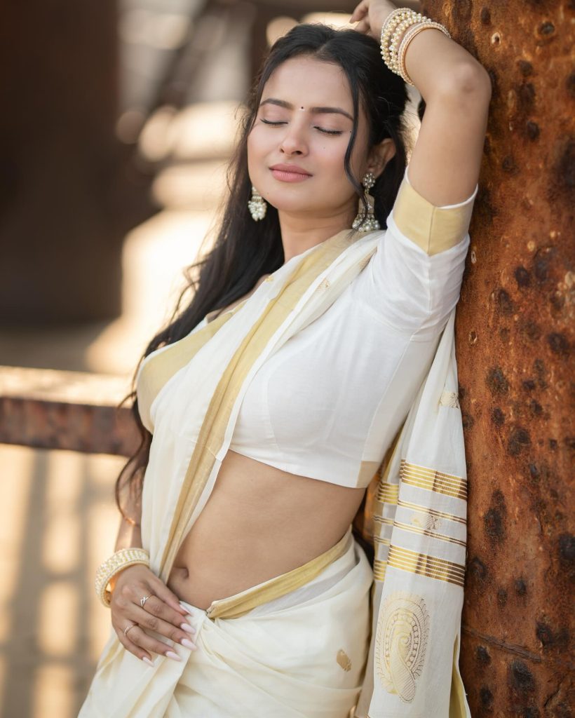 Aarushi Baruah posing gracefully in flowing white saree ensemble