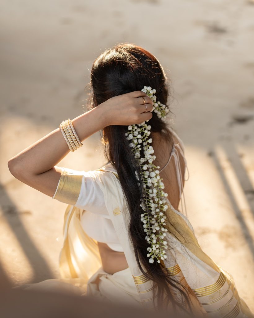 Close-up of Aarushi Baruah's makeup and styling with white saree