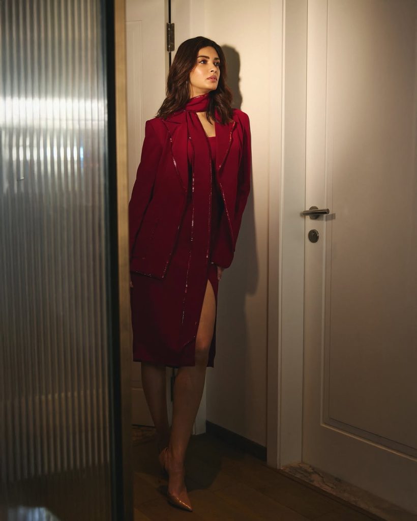 Diana Penty posing confidently in elegant red fashion outfit