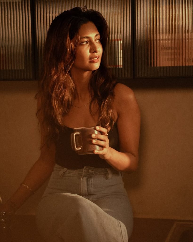 Keerthi Pandian looking cute while posing casually on comfortable couch