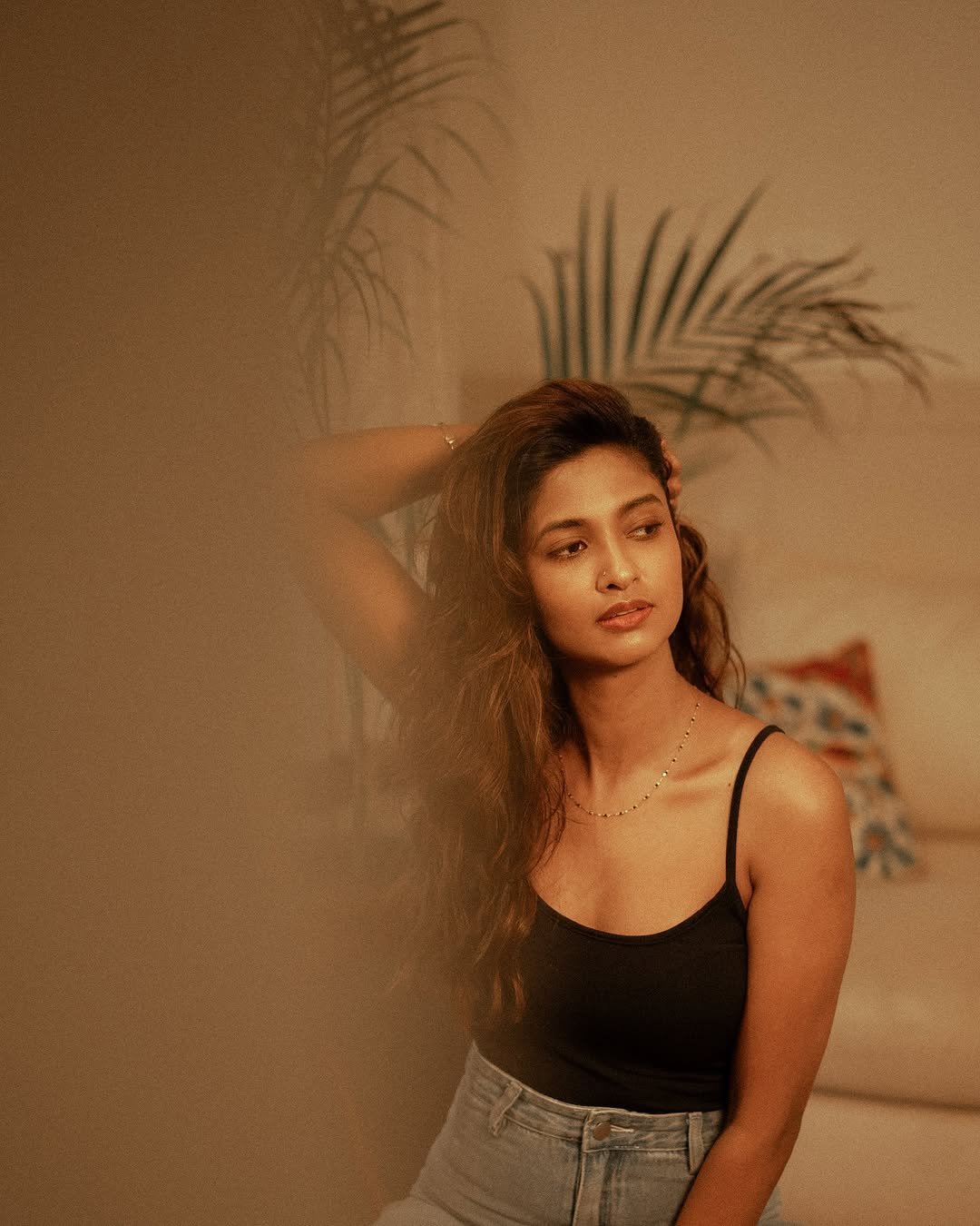 Keerthi Pandian looking cute while posing casually on comfortable couch