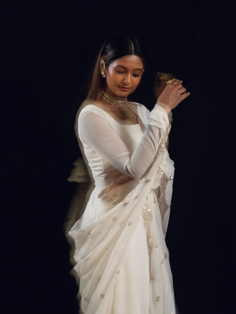 Keerthi Pandian posing gracefully in flowing white dress