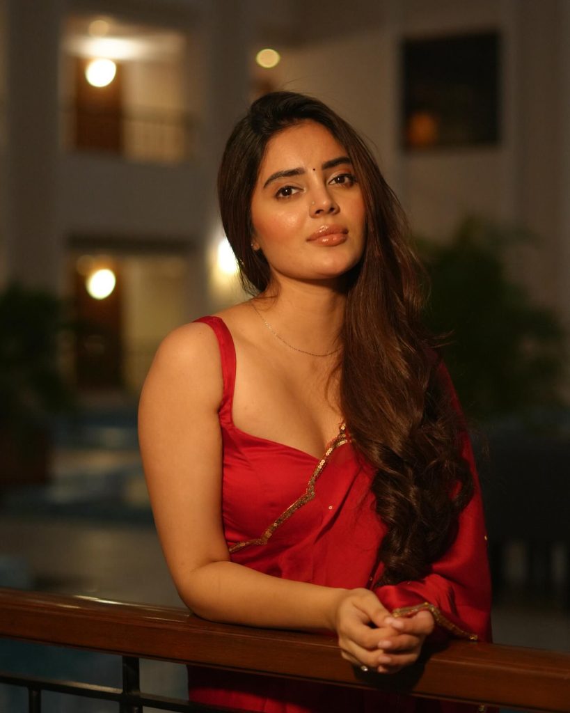 Kushitha Kallapu posing confidently in vibrant red saree