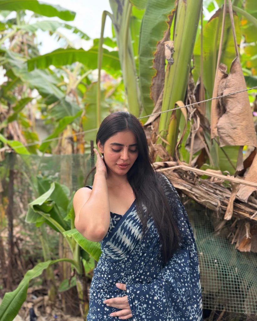 Kushitha Kallapu wearing blue saree in beautiful park setting