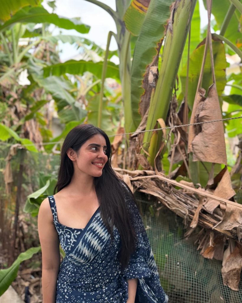 Kushitha Kallapu wearing blue saree in beautiful park setting