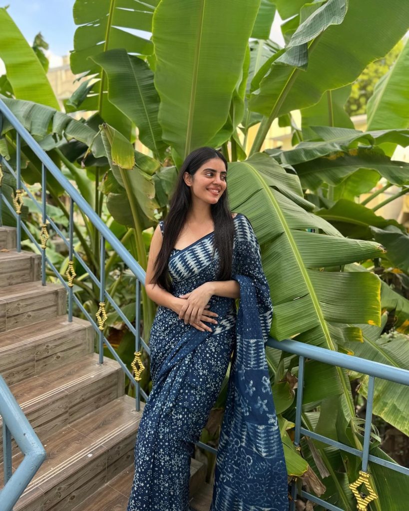Kushitha Kallapu wearing blue saree in beautiful park setting