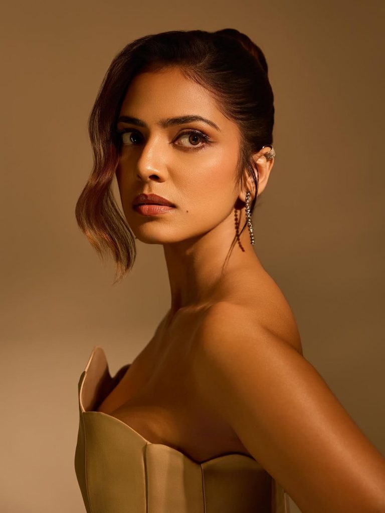 Malavika Mohanan posing elegantly in high-fashion photoshoot setting