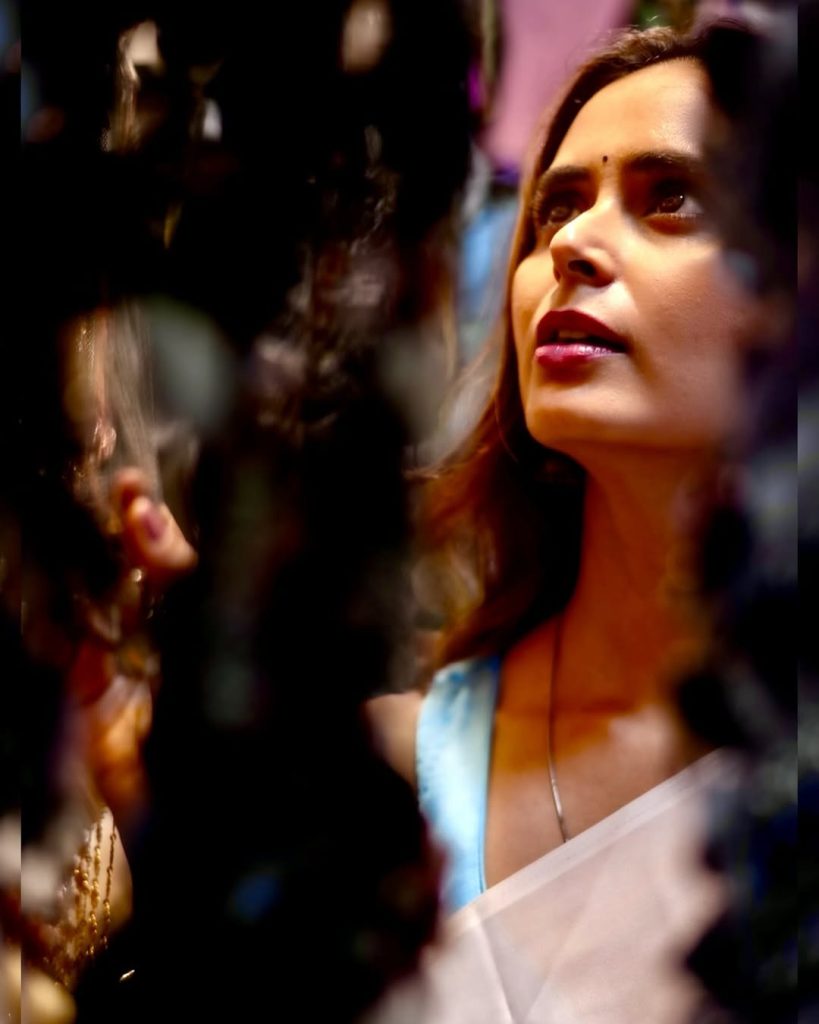 Meenakshi Dixit wearing elegant white saree in traditional photoshoot
