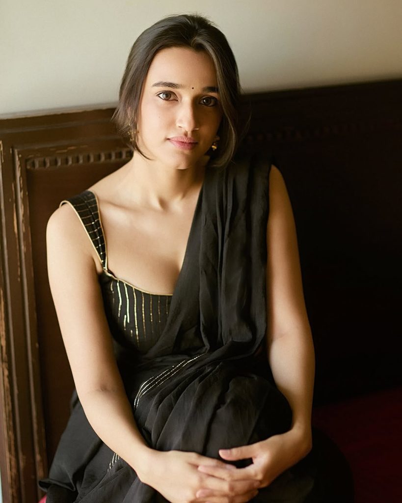 Nuveksha wearing stunning black saree in glamorous photoshoot