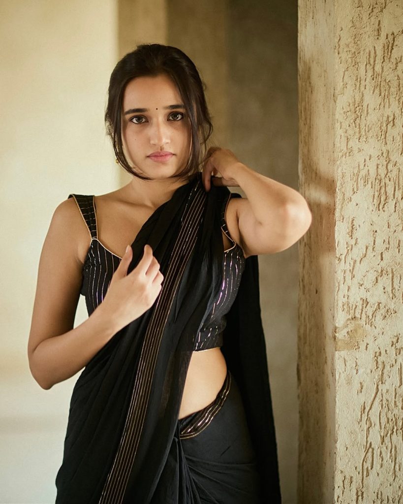 Nuveksha's complete black saree hot styling