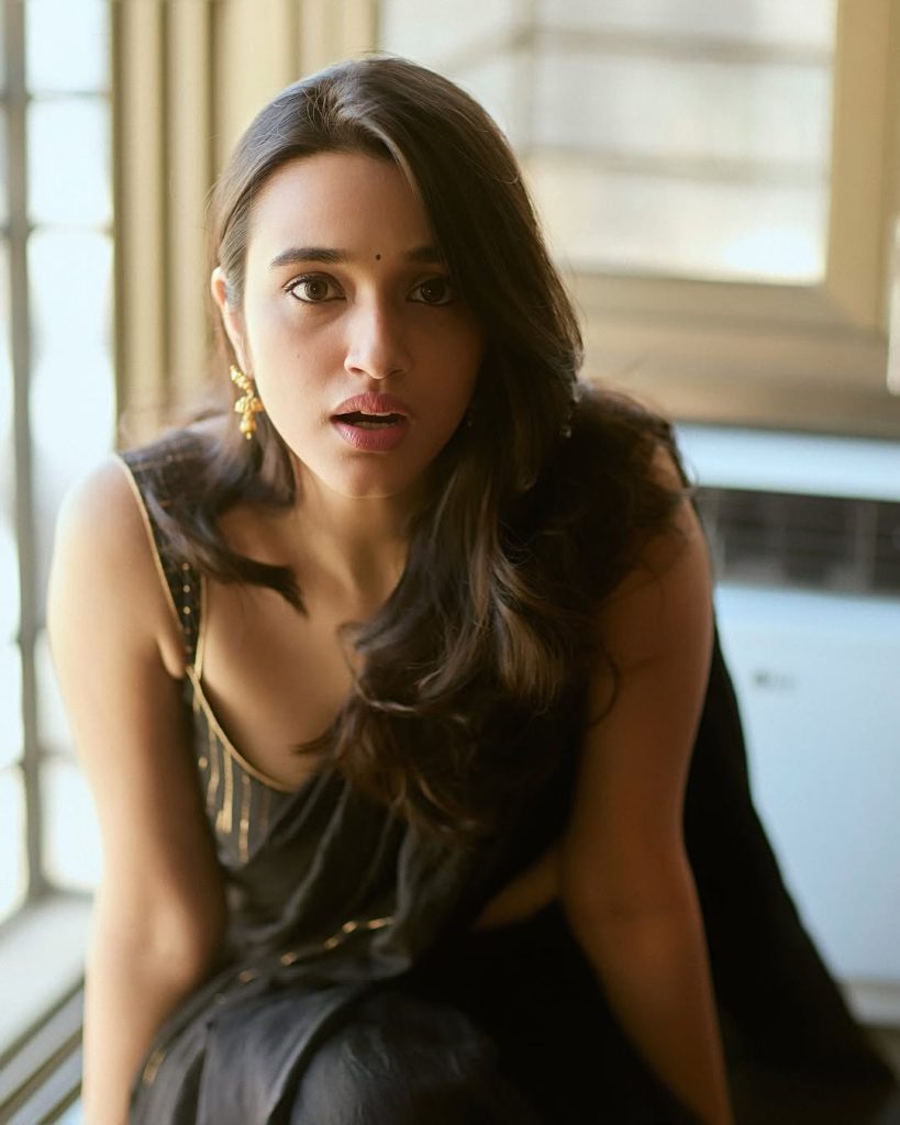 Nuveksha wearing stunning black saree in glamorous photoshoot