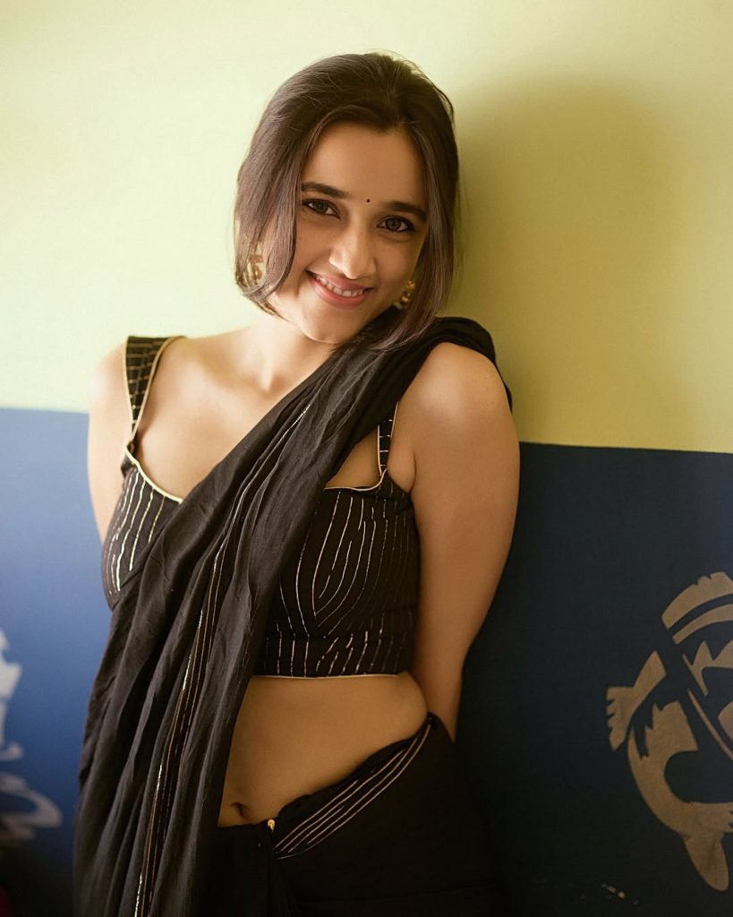 Nuveksha posing elegantly in sophisticated black saree