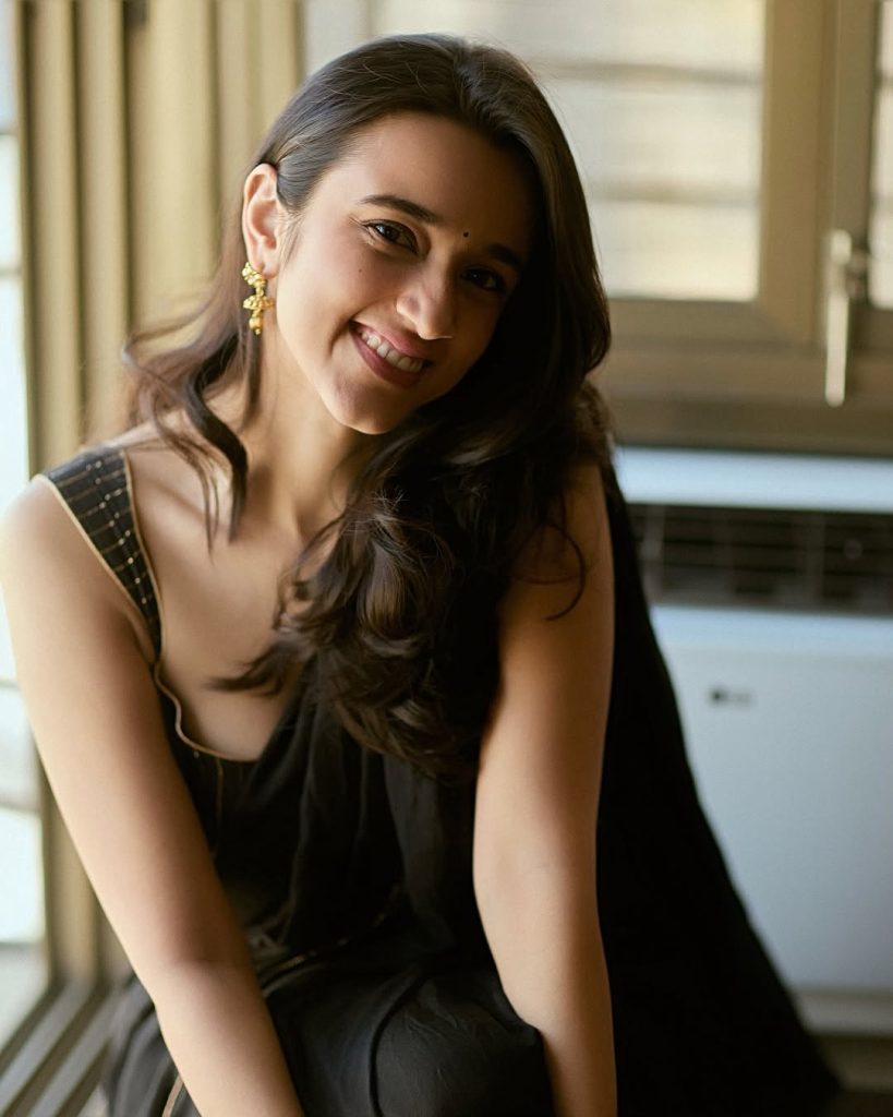 Nuveksha posing elegantly in sophisticated black saree