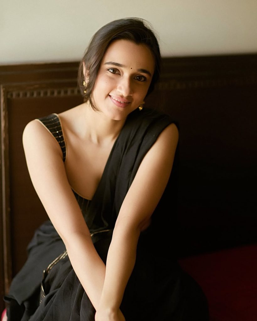 Nuveksha posing elegantly in sophisticated black saree