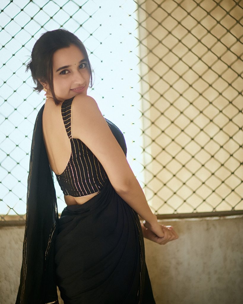 Nuveksha's bold makeup complementing black saree