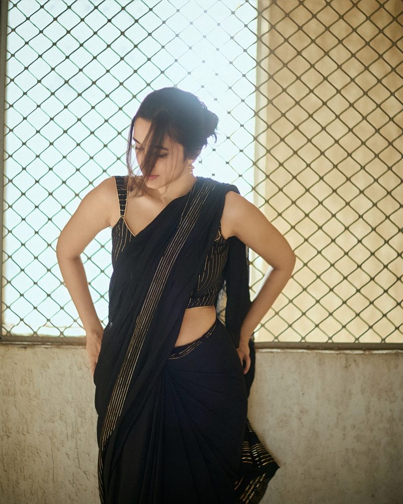 Nuveksha wearing stunning black saree in glamorous photoshoot