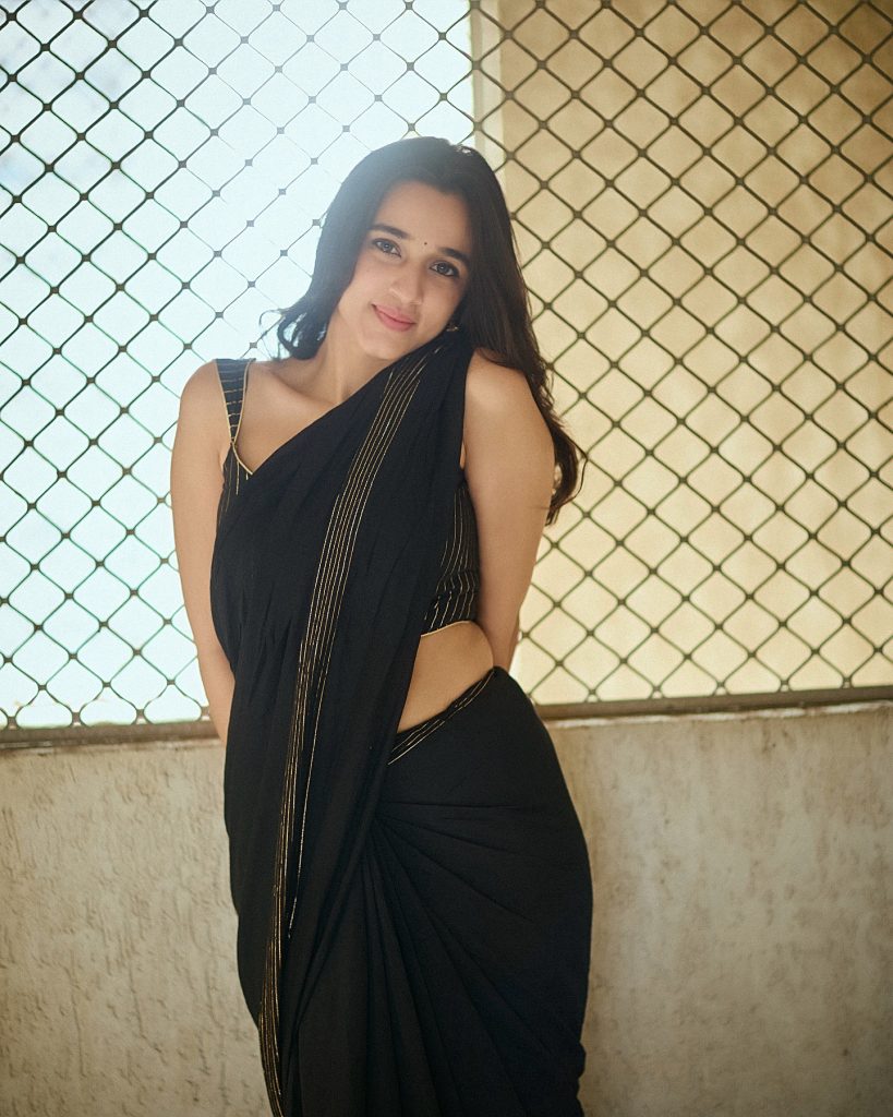 Nuveksha wearing stunning black saree in glamorous photoshoot