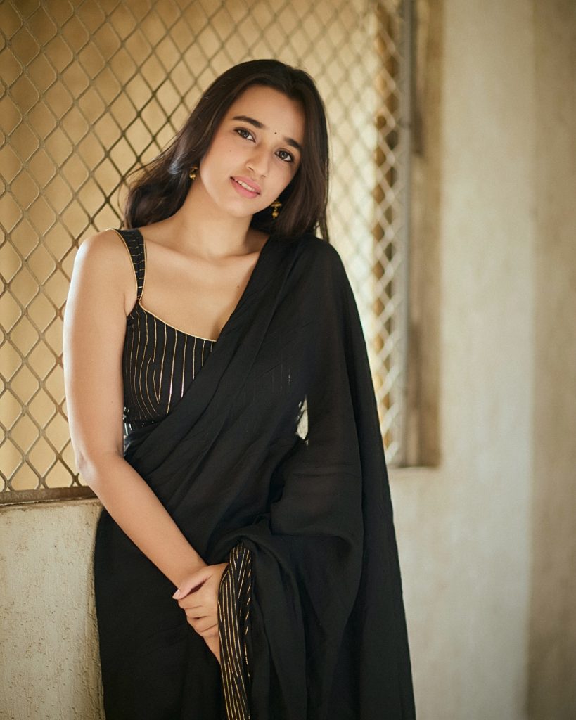 Nuveksha wearing stunning black saree in glamorous photoshoot