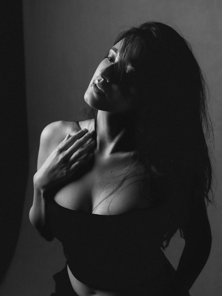 Nuveksha posing artistically in black and white fashion ensemble