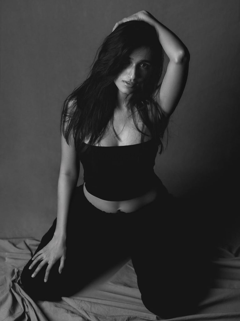 Nuveksha posing artistically in black and white fashion ensemble
