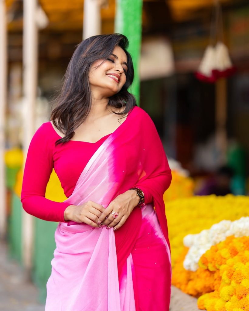 Priyanka Jain posing gracefully in flowing pink saree