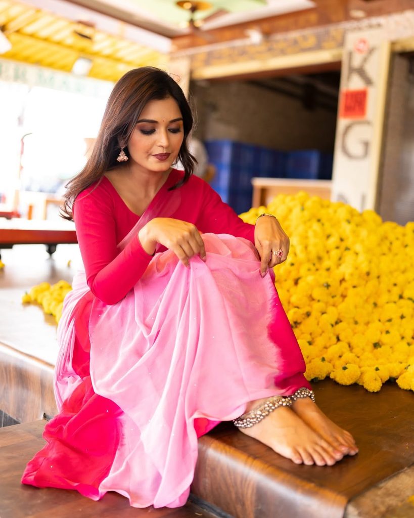 Priyanka Jain posing gracefully in flowing pink saree