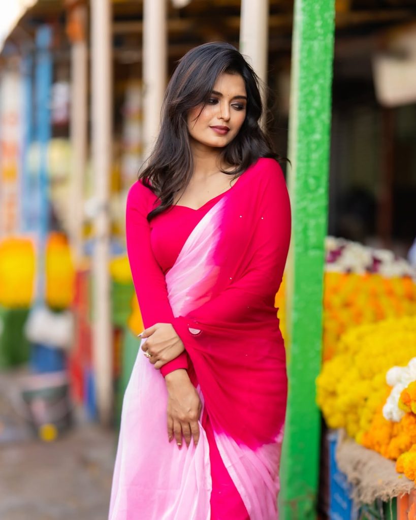 Priyanka Jain posing gracefully in flowing pink saree