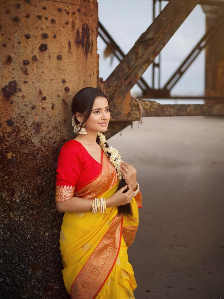 Golden yellow fabric creates luminous effect against Aarushi Baruah's soft lighting