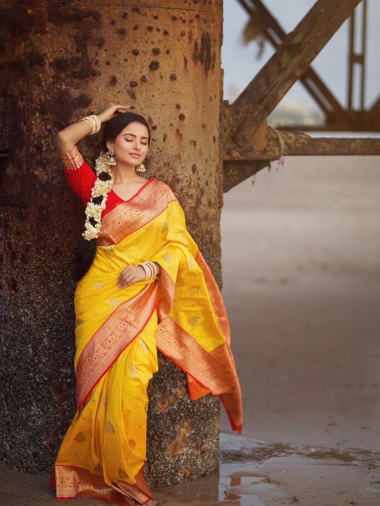 Golden yellow fabric creates luminous effect against Aarushi Baruah's soft lighting