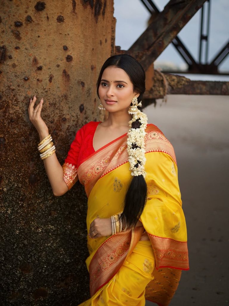 Golden yellow fabric creates luminous effect against Aarushi Baruah's soft lighting