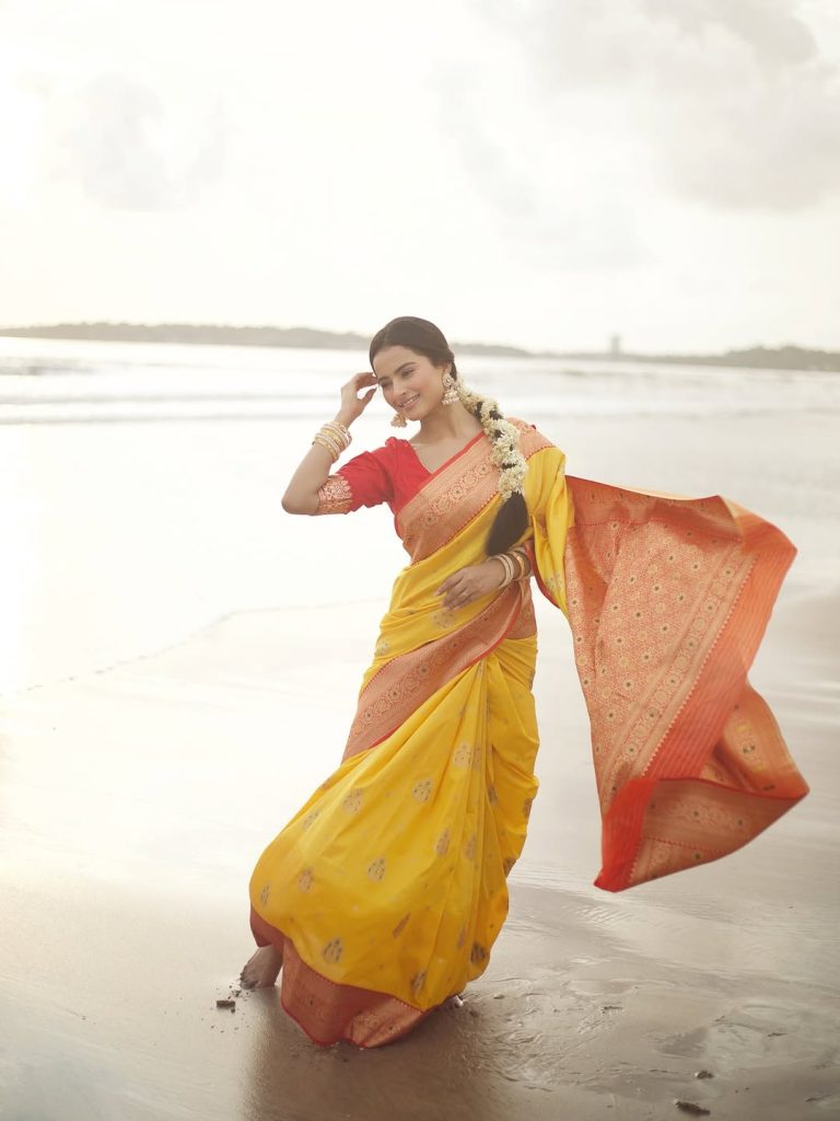 Golden yellow fabric creates luminous effect against Aarushi Baruah's soft lighting
