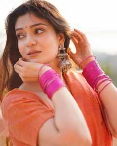 Magenta bangles add perfect color contrast to Aditi Gautam's orange saree ensemble