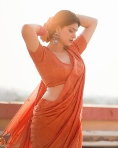 Aditi Gautam embodies colorful elegance in orange saree with magenta bangle accents