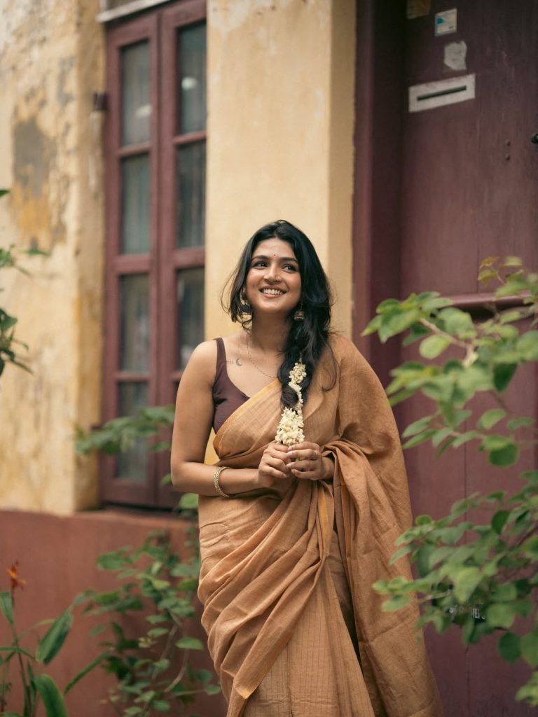 Casual saree draping highlights Anagha Ajith's natural comfort with traditional wear