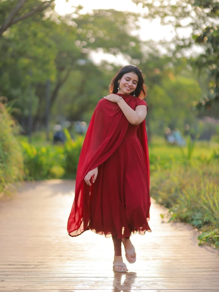 Elegant red ethnic wear showcases Arul Jyothi's cultural styling expertise
