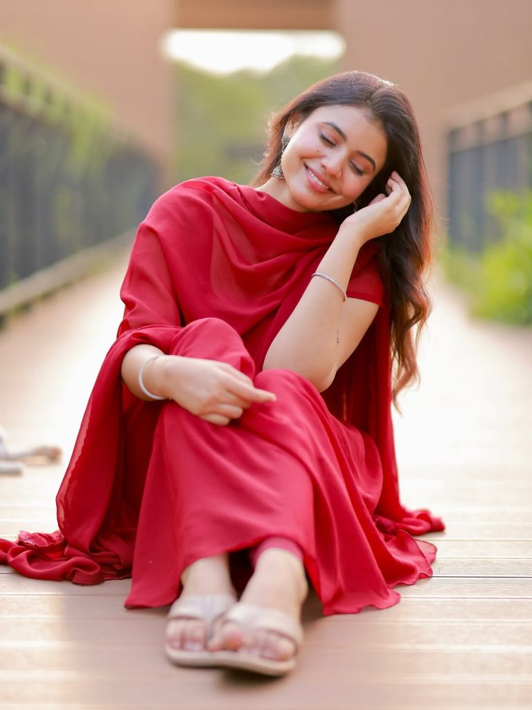 Elegant red ethnic wear showcases Arul Jyothi's cultural styling expertise
