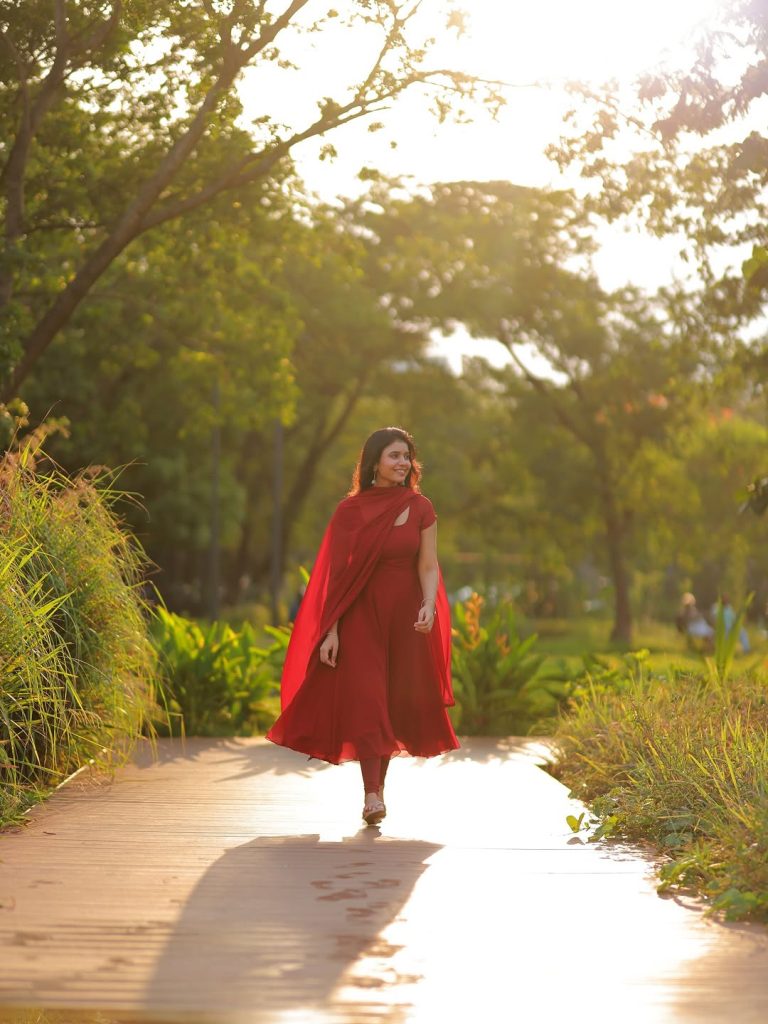Elegant red ethnic wear showcases Arul Jyothi's cultural styling expertise