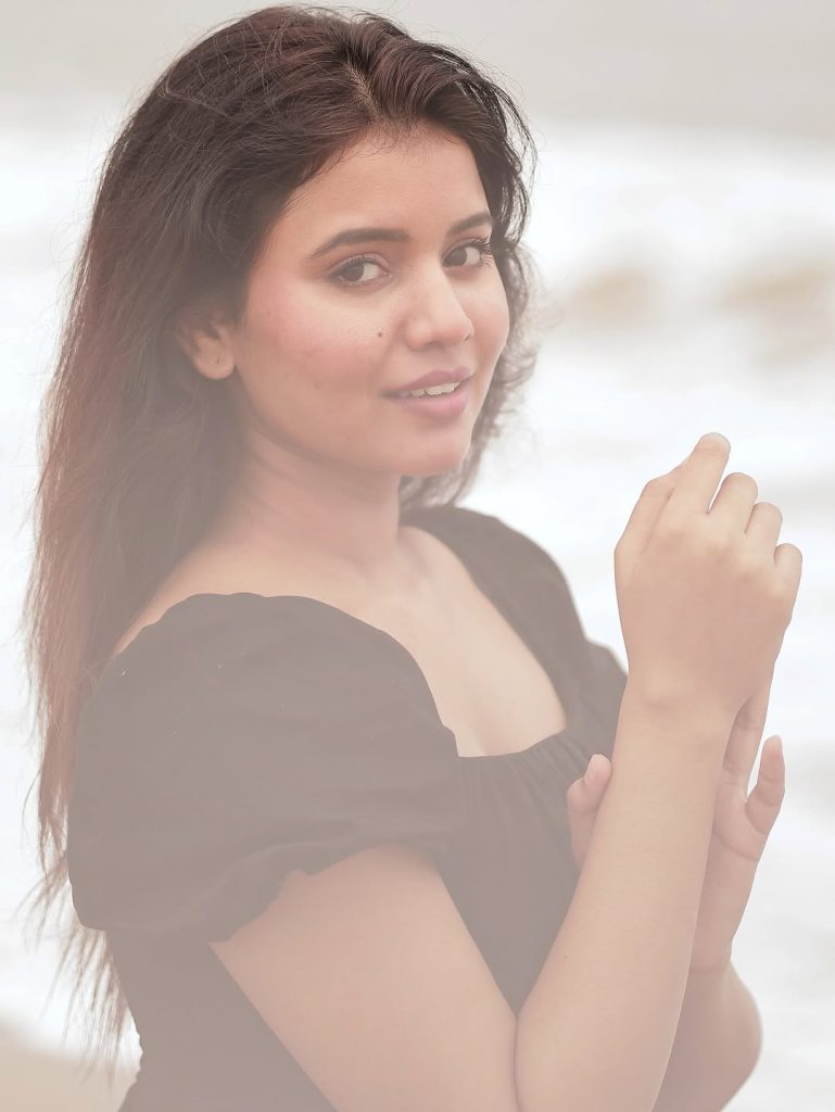Seaside setting contrasts beautifully with Arul Jyothi's elegant black outfit choice